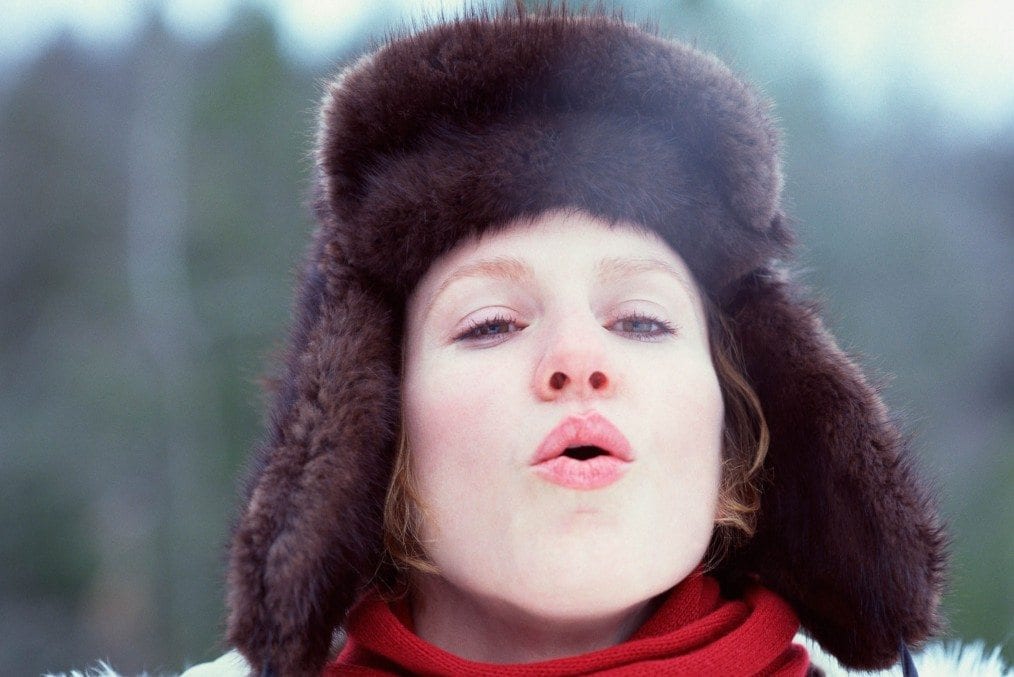 Woman breathing out in cold weather