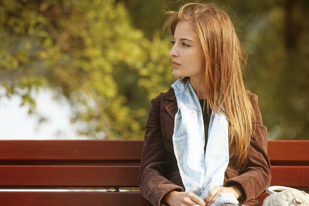 woman sitting on park bench