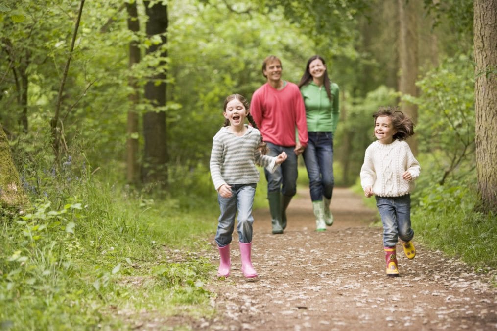 family walking through woods