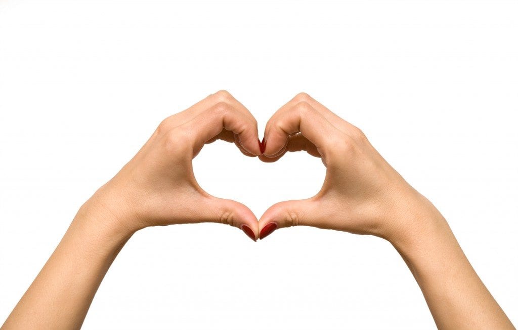 Heart shape formed with woman's hands