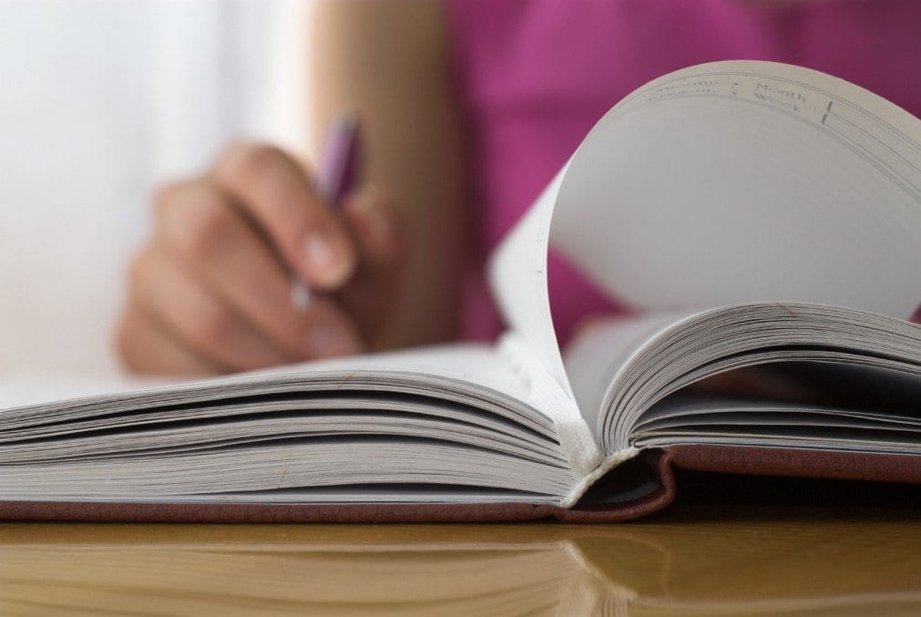 woman writing to-do list