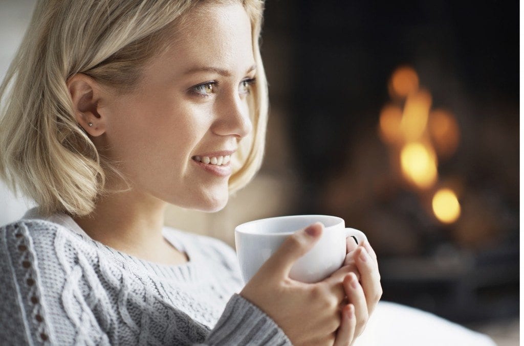 young woman holding tea cup