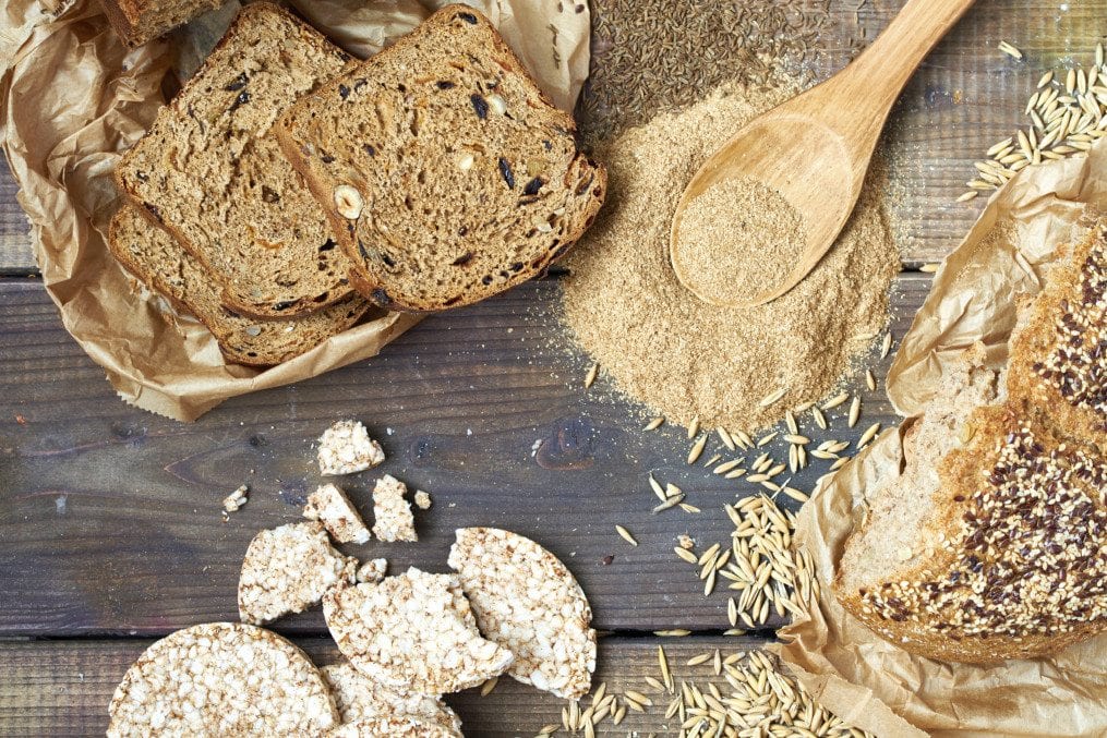 Gluten free organic bread, oat, oat bran cereal and rice cakes on table