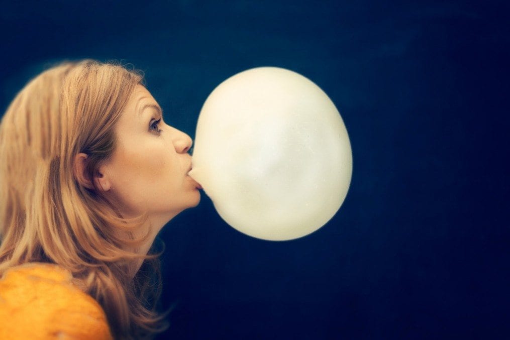woman blowing bubble gum