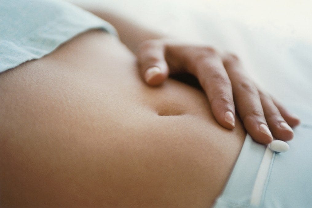 woman with hand on stomach