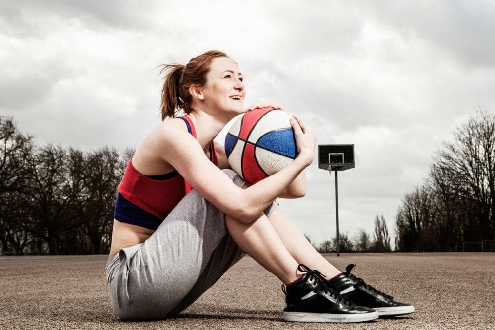 woman holding a netball
