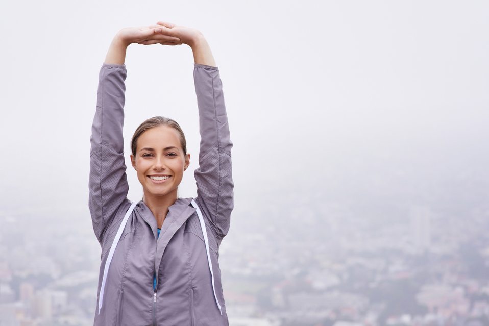 Happy woman smiling while stretching