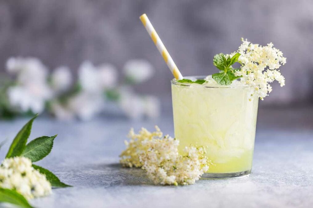 Mocktail with flowers around it