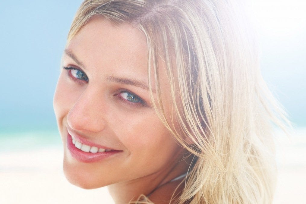 woman with good skin smiling in the sun
