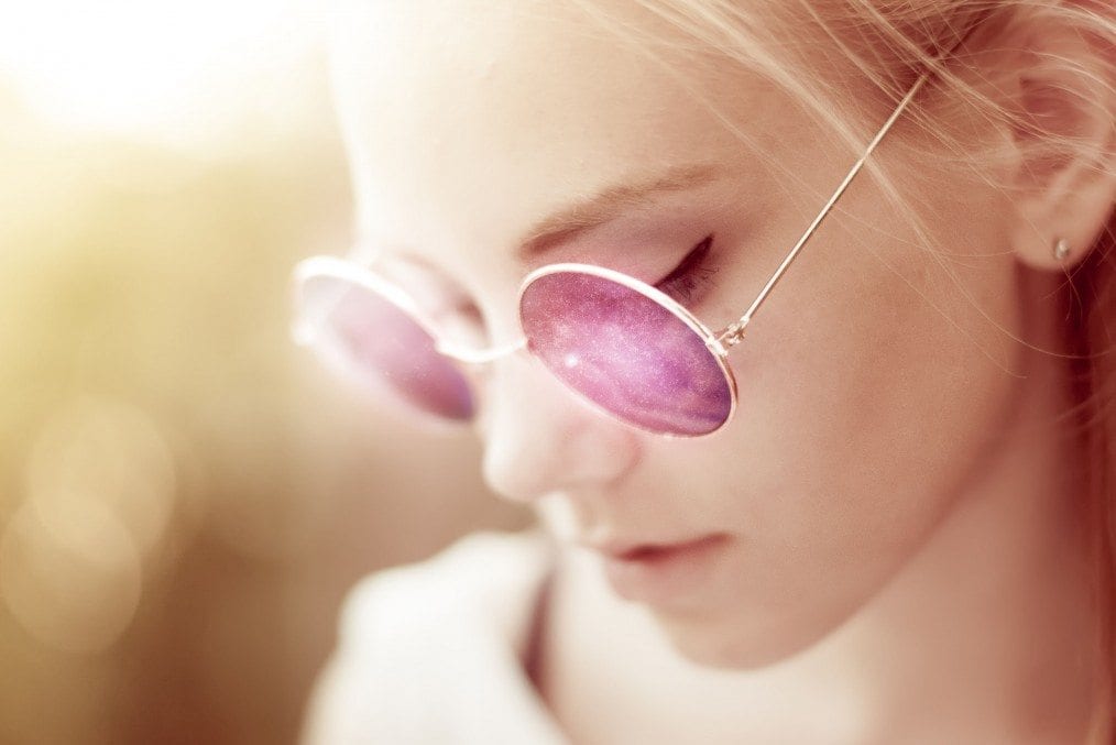 woman in sun with purple glasses on