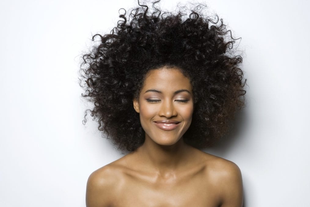 Young woman with eyes closed, smiling