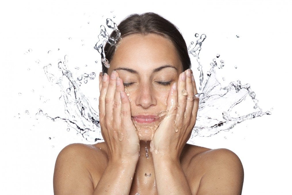 Beautiful wet woman face with water drop
