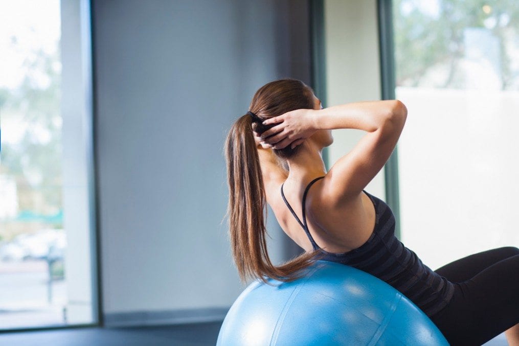 woman working on core strength with exercise ball