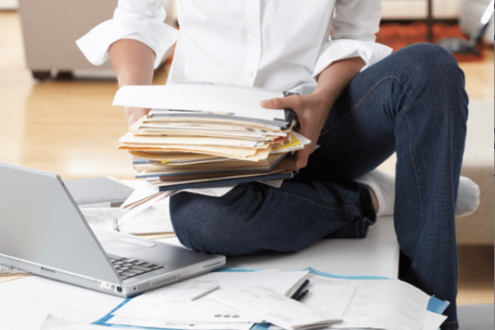 person holding a pile of files