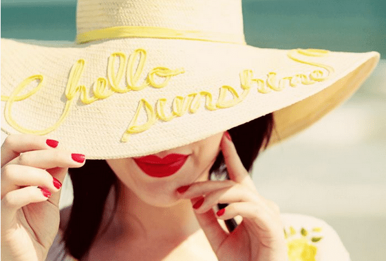 woman pulling hat down with nice nails